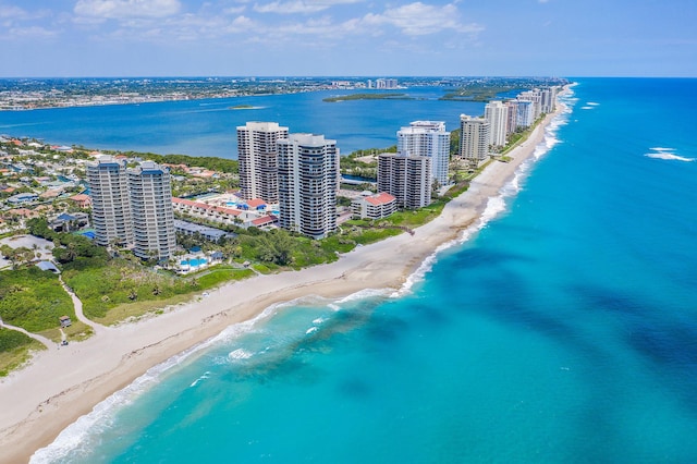 aerial view with a water view and a beach view