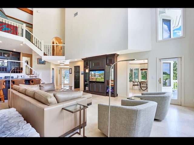 living room featuring a towering ceiling