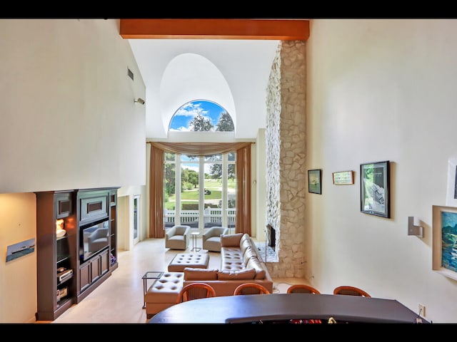 living room featuring high vaulted ceiling and beam ceiling