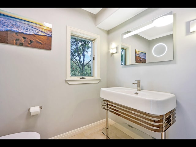 bathroom with tile patterned flooring and toilet