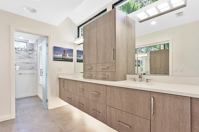 bathroom with vanity and tiled shower