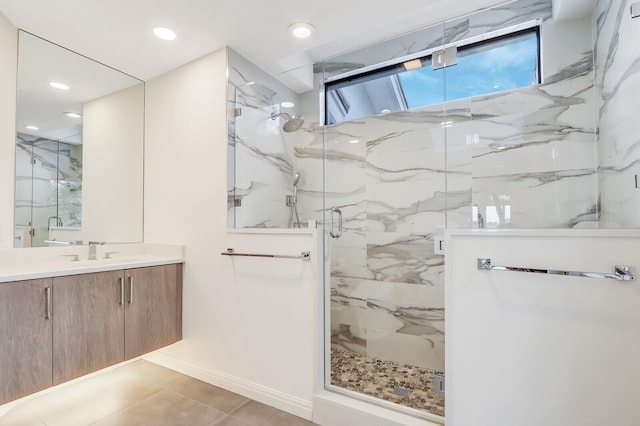 bathroom with a shower with shower door, tile patterned flooring, and vanity