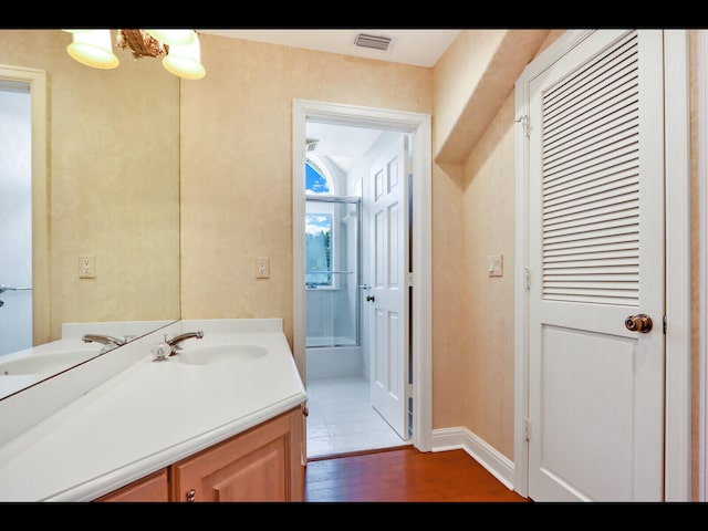 bathroom featuring hardwood / wood-style flooring and vanity