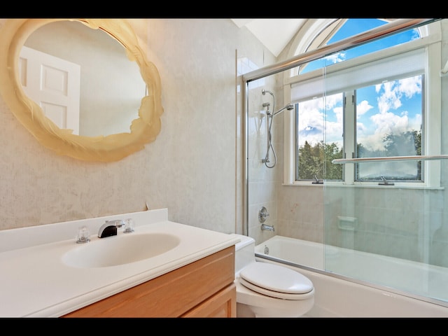 full bathroom with vanity, toilet, and enclosed tub / shower combo