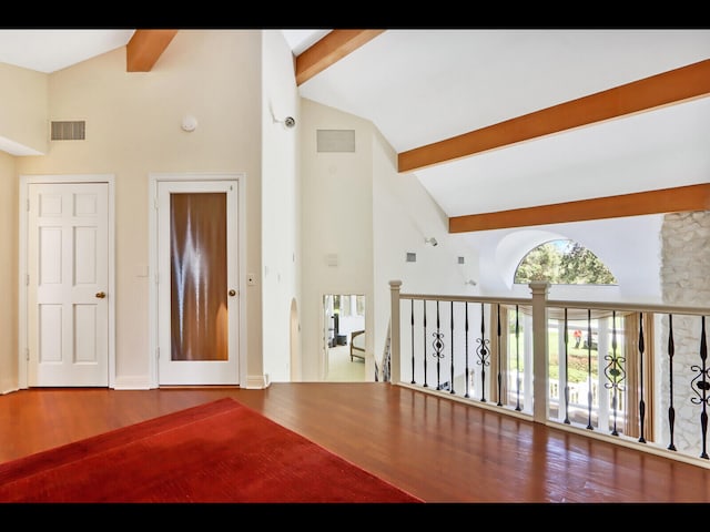 living room with high vaulted ceiling, hardwood / wood-style flooring, and beamed ceiling