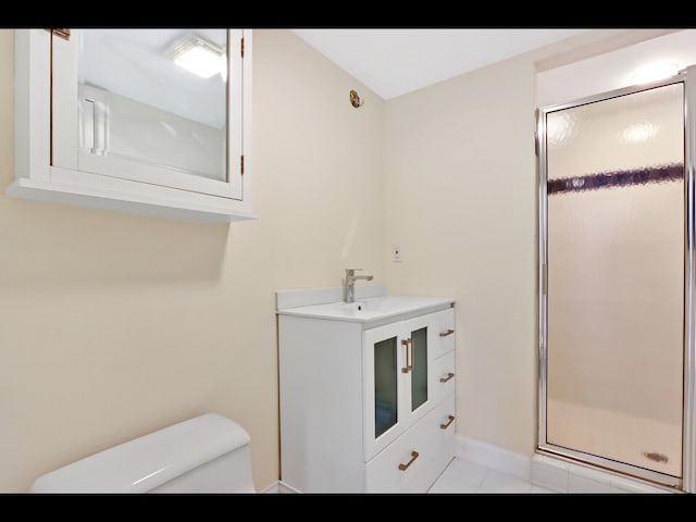 bathroom featuring vanity, toilet, an enclosed shower, and tile patterned floors