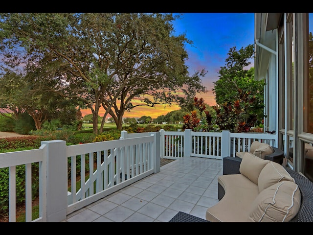 patio terrace at dusk featuring an outdoor living space