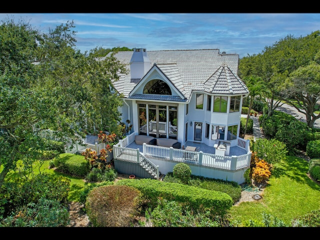 back of property with a wooden deck