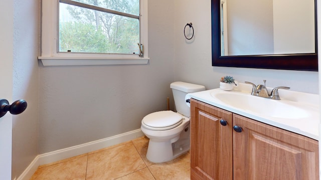 bathroom featuring toilet, baseboards, tile patterned floors, and vanity