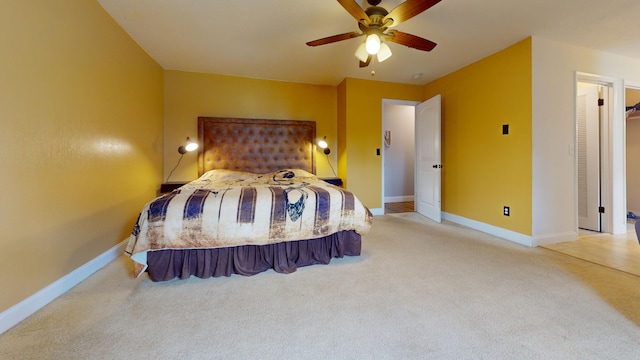 bedroom with light colored carpet, baseboards, and ceiling fan