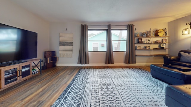 living room with baseboards and wood finished floors