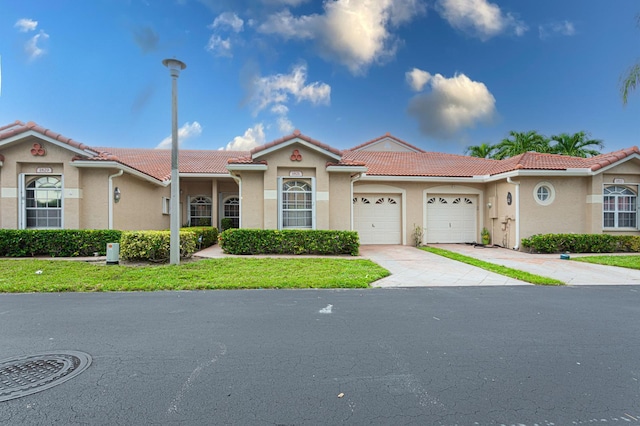 view of front of property featuring a garage and a front lawn