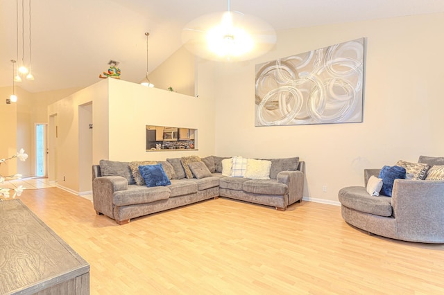 living room featuring wood-type flooring and lofted ceiling