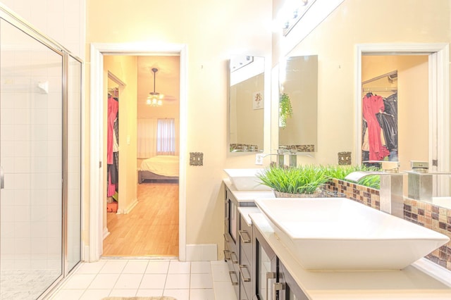 bathroom featuring walk in shower, wood-type flooring, and vanity