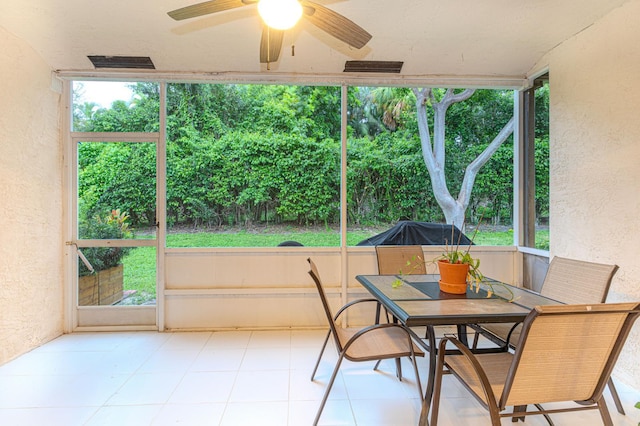 sunroom / solarium featuring a wealth of natural light and ceiling fan