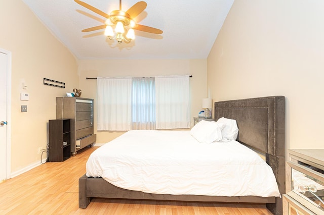 bedroom featuring vaulted ceiling, hardwood / wood-style floors, and ceiling fan