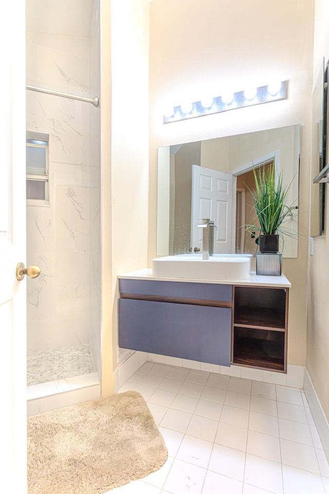 bathroom featuring a tile shower, tile patterned floors, and vanity