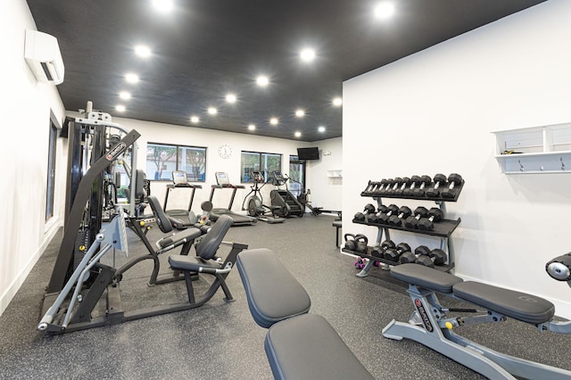 exercise room featuring an AC wall unit