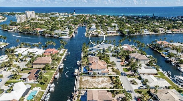 birds eye view of property with a water view and a residential view