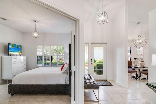 tiled bedroom featuring a chandelier