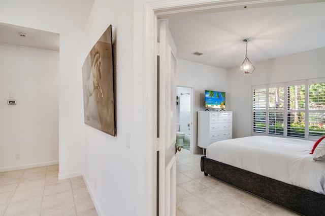 2156 Wightman Dr, Wellington, FL 33414 - bedroom with light tile patterned flooring, baseboards, visible vents, and connected bathroom