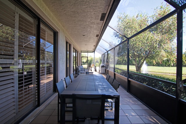 unfurnished sunroom featuring vaulted ceiling