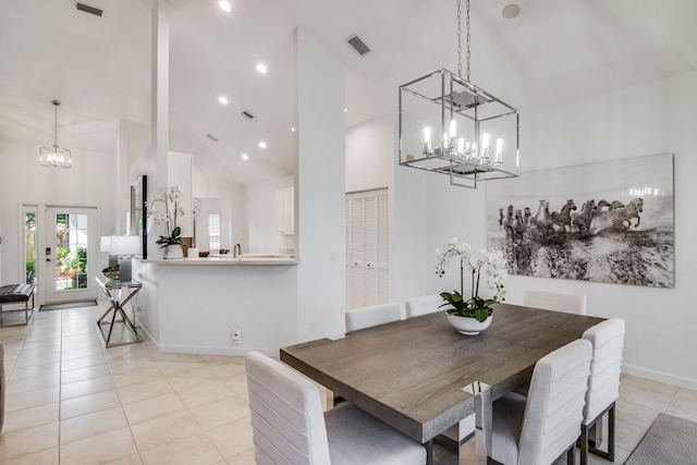 tiled dining space featuring high vaulted ceiling