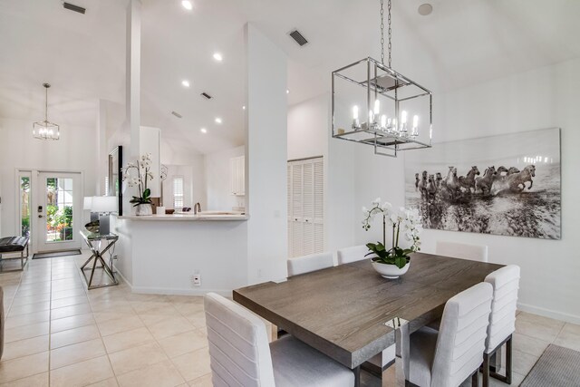 2156 Wightman Dr, Wellington, FL 33414 - dining area featuring a notable chandelier, baseboards, light tile patterned floors, a high ceiling, and visible vents