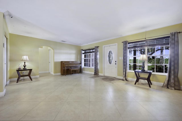 tiled entryway with a healthy amount of sunlight and ornamental molding