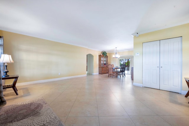 living room featuring light tile patterned floors, ornamental molding, and an inviting chandelier