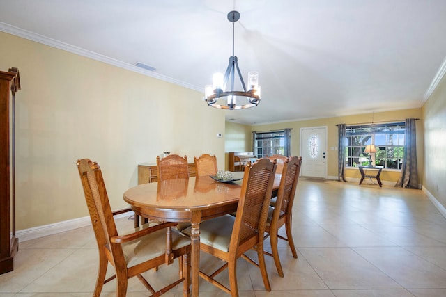 tiled dining area featuring a chandelier and crown molding