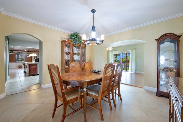 tiled dining room featuring ceiling fan with notable chandelier and crown molding