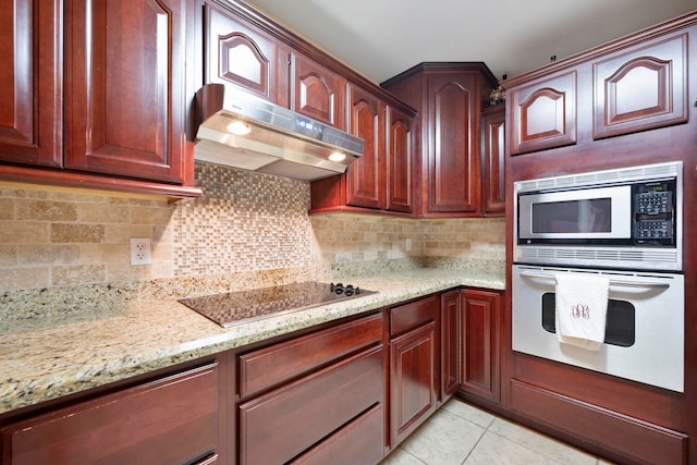 kitchen with decorative backsplash, wall oven, black electric cooktop, built in microwave, and light tile patterned floors