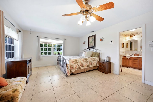 bedroom with connected bathroom, ceiling fan, and light tile patterned flooring