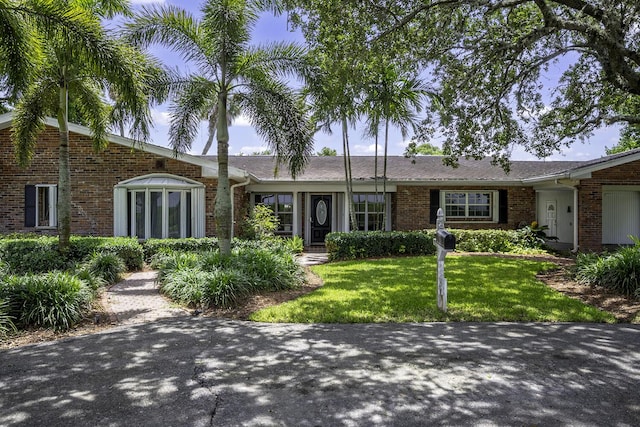 ranch-style house with a front lawn