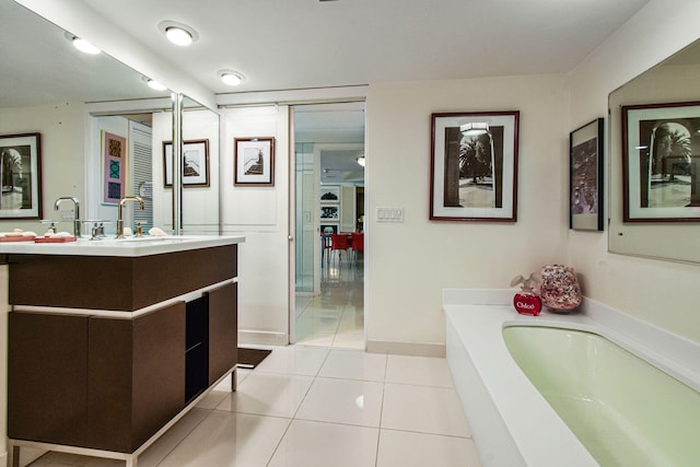 bathroom featuring tile patterned floors, a bathtub, and vanity