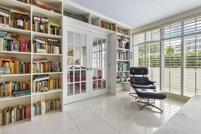 sitting room featuring light tile patterned floors and french doors