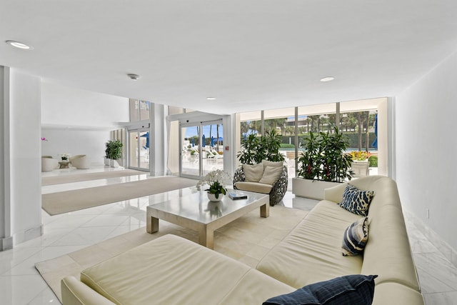 tiled living room featuring a wall of windows