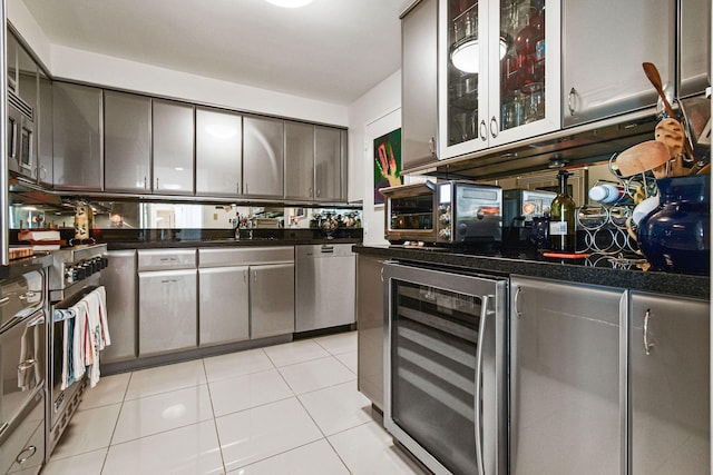 kitchen featuring light tile patterned flooring, sink, stainless steel appliances, and wine cooler