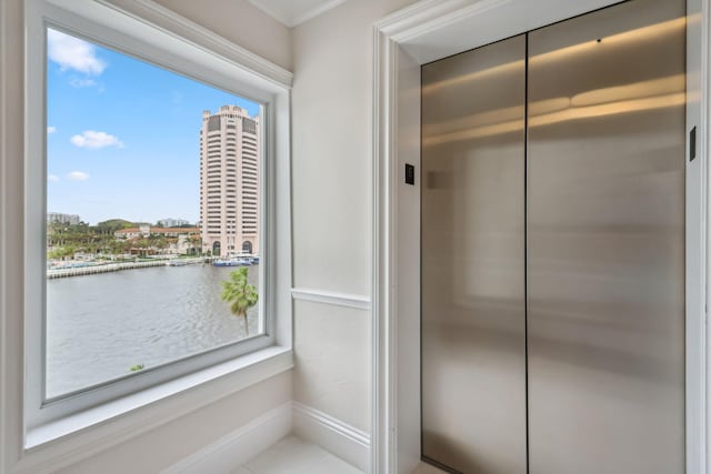 interior space featuring a water view and elevator