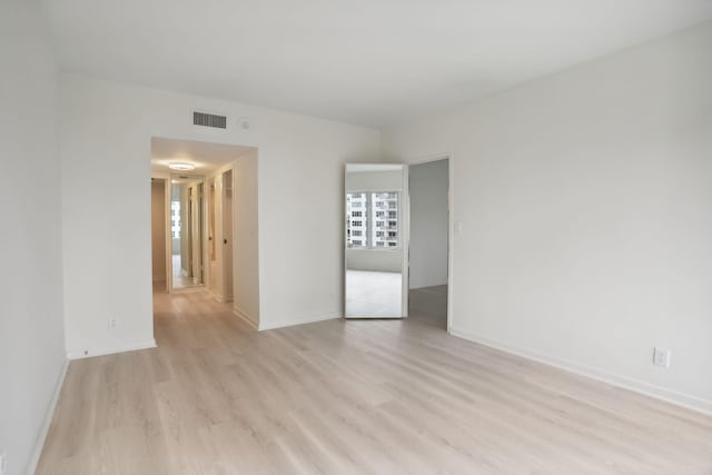 empty room with light hardwood / wood-style floors