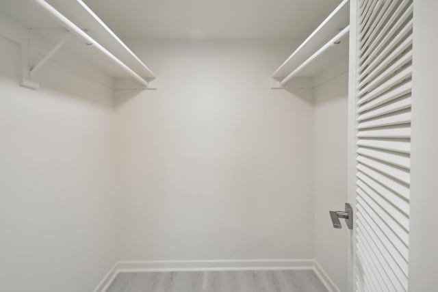 spacious closet with light hardwood / wood-style floors