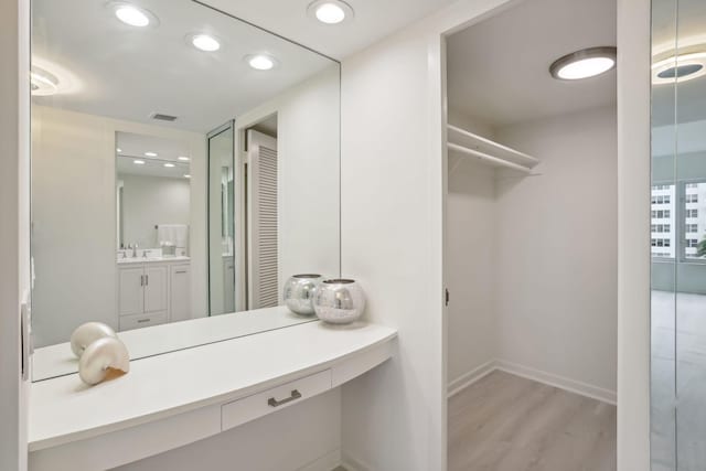 bathroom with vanity and wood-type flooring