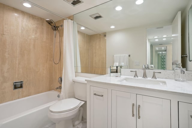 full bathroom featuring oversized vanity, toilet, and shower / bathtub combination with curtain