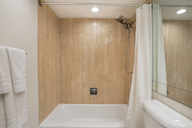 bathroom featuring toilet and shower / tub combo