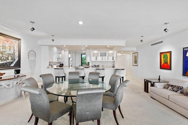 dining area with light carpet and ornamental molding