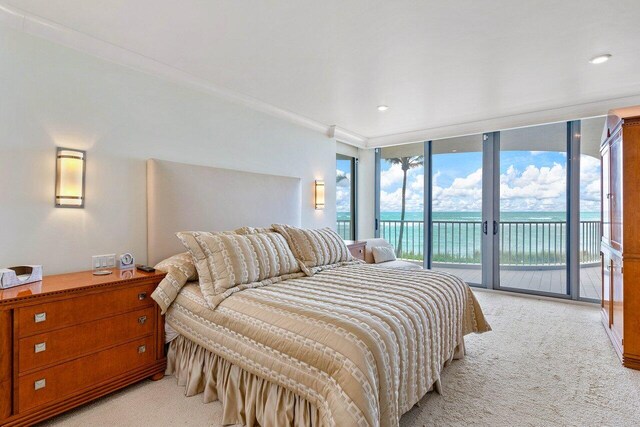 bedroom featuring light carpet, floor to ceiling windows, ornamental molding, and access to outside