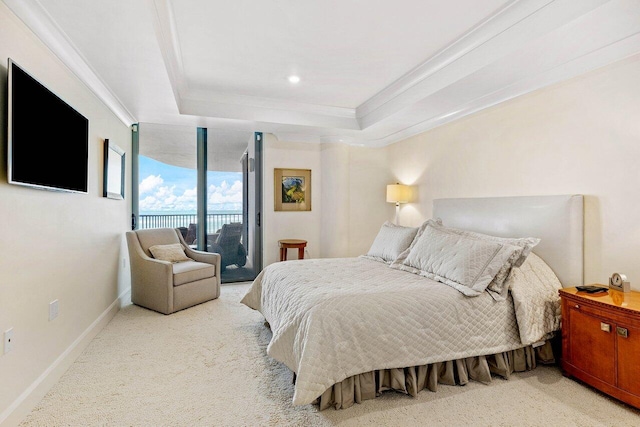 carpeted bedroom with crown molding, a tray ceiling, and access to exterior