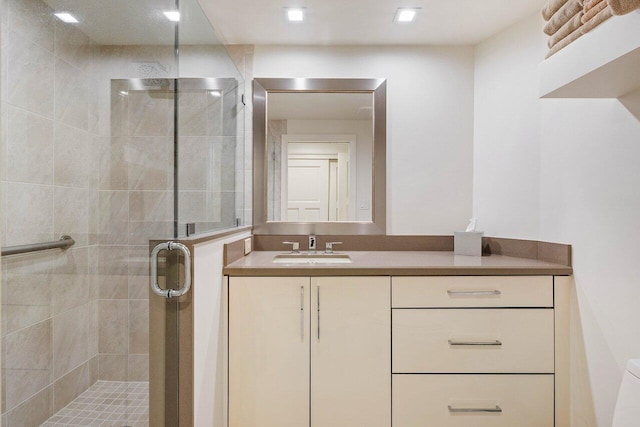 bathroom with vanity and a shower with shower door