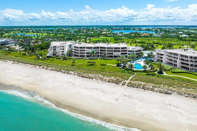 birds eye view of property featuring a beach view and a water view